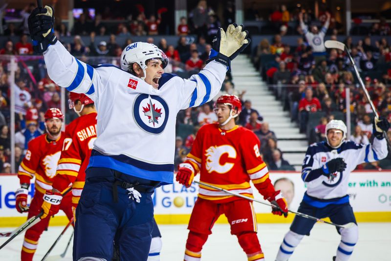 Feb 19, 2024; Calgary, Alberta, CAN; Winnipeg Jets center Sean Monahan (23) celebrates his goal against the Calgary Flames during the first period at Scotiabank Saddledome. Mandatory Credit: Sergei Belski-USA TODAY Sports