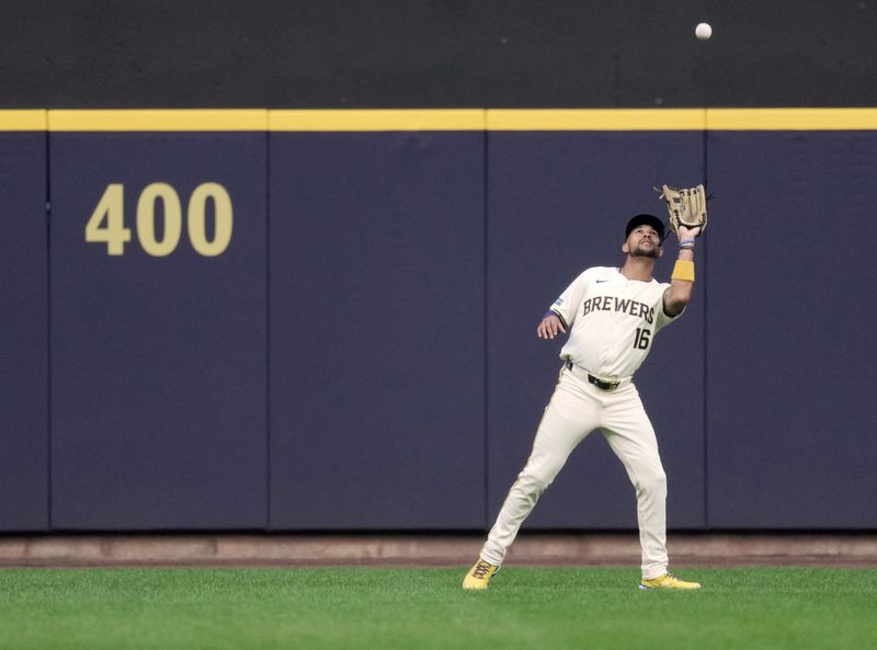 Jul 10, 2024; Milwaukee, Wisconsin, USA; Milwaukee Brewers outfielder Blake Perkins (16) catches a fly ball hit by Pittsburgh Pirates first baseman Rowdy Tellez (not pictured) during the first inning at American Family Field in Milwaukee, Wisconsin.  Mandatory Credit: Mark Hoffman-USA TODAY Sports