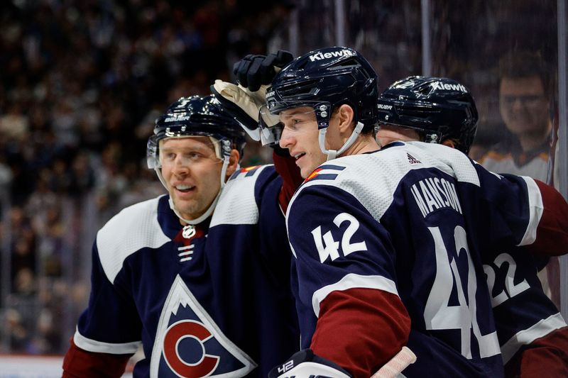 Dec 23, 2023; Denver, Colorado, USA; Colorado Avalanche defenseman Josh Manson (42) celebrates his goal with left wing Fredrik Olofsson (22) and defenseman Jack Johnson (3) in the second period against the Arizona Coyotes at Ball Arena. Mandatory Credit: Isaiah J. Downing-USA TODAY Sports