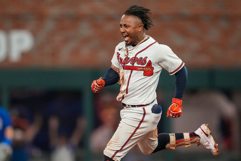 Sep 27, 2023; Cumberland, Georgia, USA; Atlanta Braves second baseman Ozzie Albies (1) reacts after getting the game winning hit against the Chicago Cubs during the tenth inning at Truist Park. Mandatory Credit: Dale Zanine-USA TODAY Sports