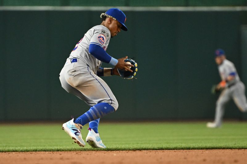 Jul 1, 2024; Washington, District of Columbia, USA; New York Mets shortstop Francisco Lindor (12) fields a ground ball against the Washington Nationals during the eighth inning at Nationals Park. Mandatory Credit: Rafael Suanes-USA TODAY Sports