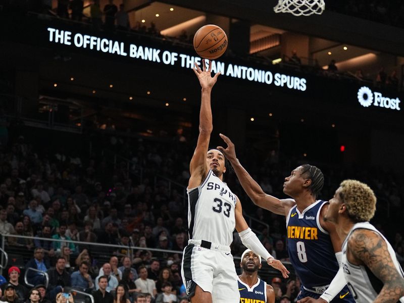 AUSTIN, TX - MARCH 15: Tre Jones #33 of the San Antonio Spurs drives to the basket during the game against the Denver Nuggets on March 15, 2024 at the Moody Center in Austin, Texas. NOTE TO USER: User expressly acknowledges and agrees that, by downloading and/or using this Photograph, user is consenting to the terms and conditions of the Getty Images License Agreement. Mandatory Copyright Notice: Copyright 2024 NBAE (Photo by Garrett Ellwood/NBAE via Getty Images)