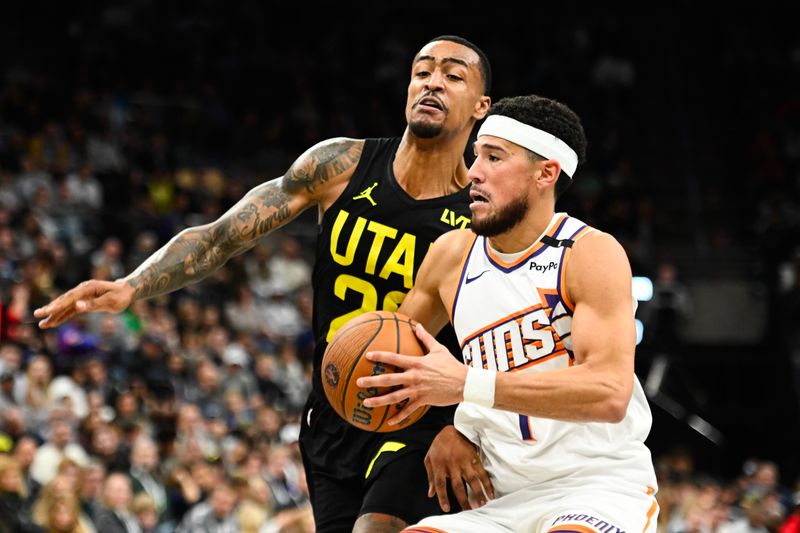 SALT LAKE CITY, UTAH - NOVEMBER 12: Devin Booker #1 of the Phoenix Suns drives into John Collins #20 of the Utah Jazz during the second half of a Emirates NBA Cup game at Delta Center on November 12, 2024 in Salt Lake City, Utah. NOTE TO USER: User expressly acknowledges and agrees that, by downloading and or using this photograph, User is consenting to the terms and conditions of the Getty Images License Agreement. (Photo by Alex Goodlett/Getty Images)