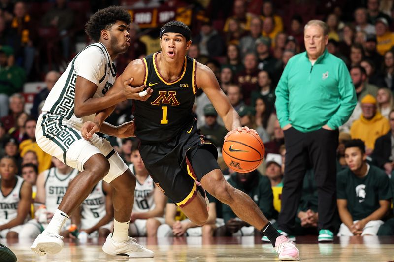 Dec 4, 2024; Minneapolis, Minnesota, USA; Minnesota Golden Gophers guard Isaac Asuma (1) works around Michigan State Spartans guard Jase Richardson (11) during the first half at Williams Arena. Mandatory Credit: Matt Krohn-Imagn Images