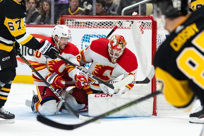 Oct 14, 2023; Pittsburgh, Pennsylvania, USA; Calgary Flames goalie Jacob Markstrom (25) makes a save with help from center Blake Coleman (20) on a shot by Pittsburgh Penguins center Sidney Crosby (87) during the first period at PPG Paints Arena. Mandatory Credit: Scott Galvin-USA TODAY Sports