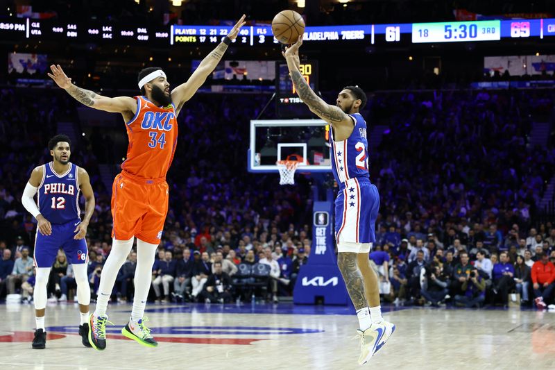 PHILADELPHIA, PENNSYLVANIA - APRIL 02: Cameron Payne #22 of the Philadelphia 76ers shoots past Kenrich Williams #34 of the Oklahoma City Thunder during the third quarter at the Wells Fargo Center on April 02, 2024 in Philadelphia, Pennsylvania. NOTE TO USER: User expressly acknowledges and agrees that, by downloading and or using this photograph, User is consenting to the terms and conditions of the Getty Images License Agreement. (Photo by Tim Nwachukwu/Getty Images)