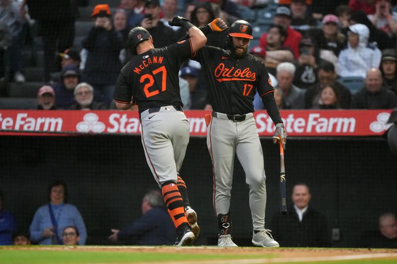 Apr 22, 2024; Anaheim, California, USA; Baltimore Orioles catcher James McCann (27) celebrates with left fielder Colton Cowser (17) after hitting a solo home run in the second inning against the Los Angeles Angels at Angel Stadium. Mandatory Credit: Kirby Lee-USA TODAY Sports