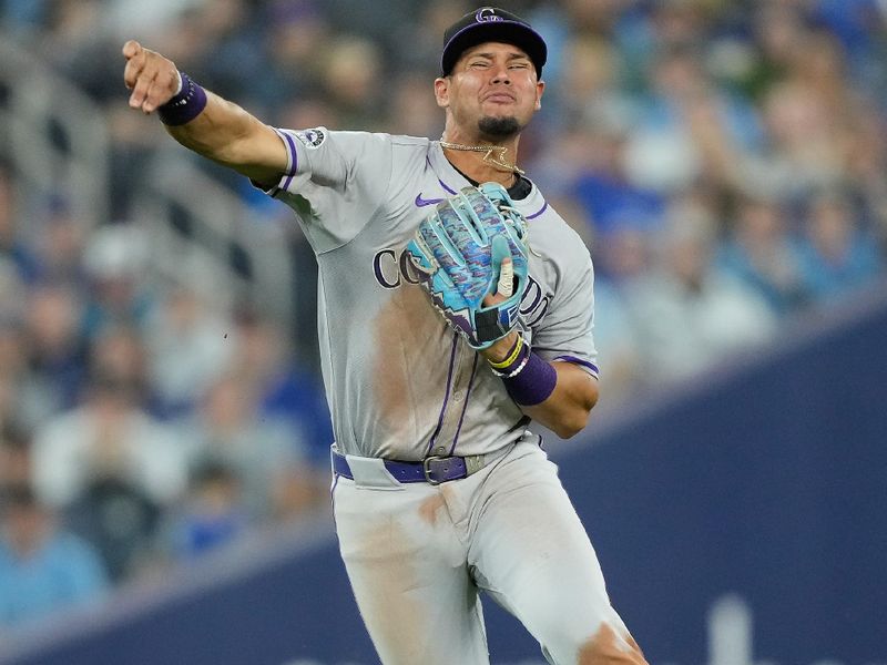 Apr 14, 2024; Toronto, Ontario, CAN; Colorado Rockies shortstop Ezequiel Tovar (14) throws out Toronto Blue Jays shortstop Bo Bichette (not pictured) at first base during the seventh inning at Rogers Centre. Mandatory Credit: John E. Sokolowski-USA TODAY Sports