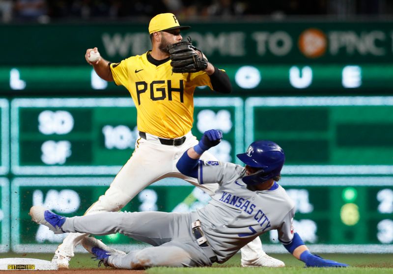 Sep 13, 2024; Pittsburgh, Pennsylvania, USA;  Pittsburgh Pirates shortstop Isiah Kiner-Falefa (top) throws to first base to complete a double play over Kansas City Royals shortstop Bobby Witt Jr. (7) during the seventh inning at PNC Park. Mandatory Credit: Charles LeClaire-Imagn Images