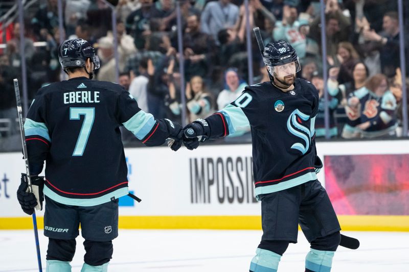 Jan 24, 2024; Seattle, Washington, USA; Seattle Kraken forward Tomas Tatar (90) is congratulated by forward Jordan Eberle (7) after scoring a goal against the Chicago Blackhawks during the third period at Climate Pledge Arena. Mandatory Credit: Stephen Brashear-USA TODAY Sports