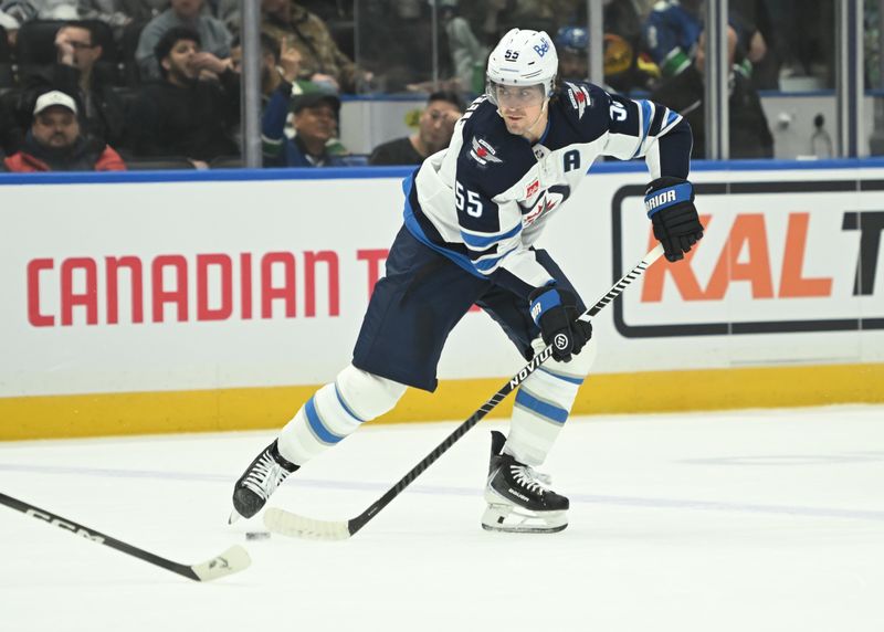Feb 25, 2026; Vancouver, British Columbia, CAN; Winnipeg Jets center Mark Scheifele (55) skates with the puck against against the Vancouver Canucks during first period at Rogers Arena. Mandatory Credit: Simon Fearn-Imagn Images