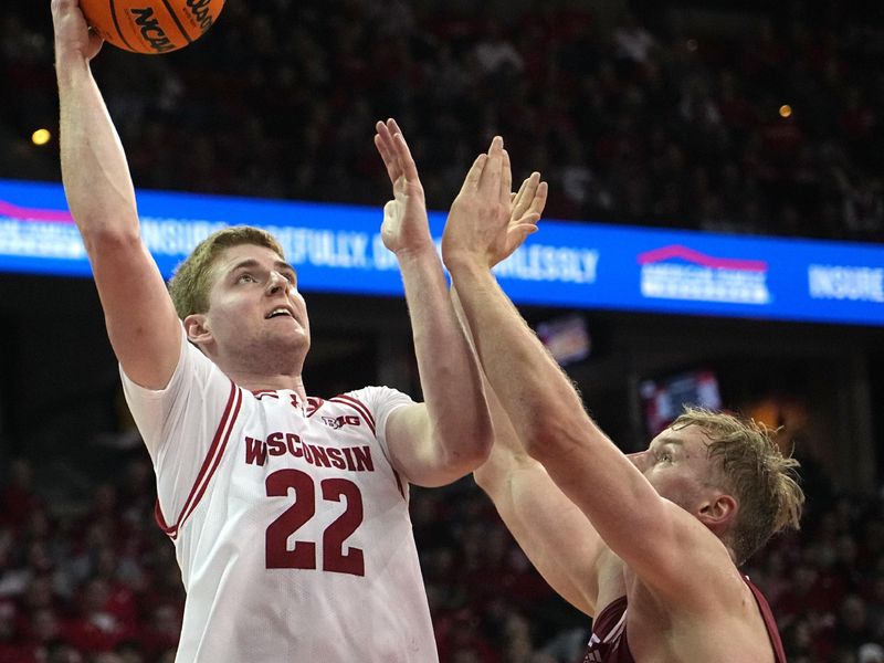 Jan 6, 2024; Madison, Wisconsin, USA; Wisconsin forward Steven Crowl (22) scores on Nebraska forward Rienk Mast (51) during the second half at Kohl Center. Mandatory Credit: Mark Hoffman-USA TODAY Sports