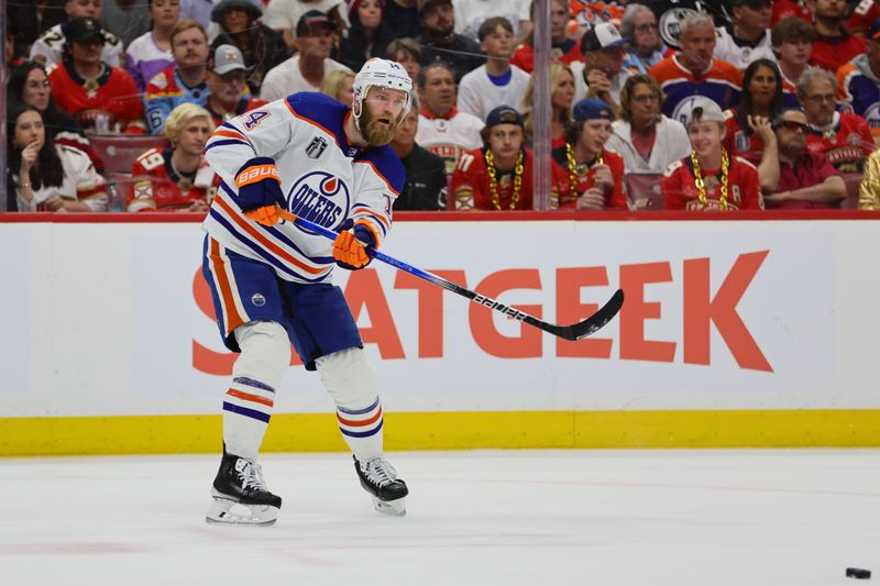 Jun 10, 2024; Sunrise, Florida, USA; Edmonton Oilers defenseman Mattias Ekholm (14) passes the puck during the second period against the Florida Panthers in game two of the 2024 Stanley Cup Final at Amerant Bank Arena. Mandatory Credit: Sam Navarro-USA TODAY Sports