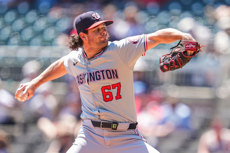 Aug 25, 2024; Cumberland, Georgia, USA; Washington Nationals relief pitcher Kyle Finnegan (67) pitches against the Atlanta Braves during the ninth inning at Truist Park. Mandatory Credit: Dale Zanine-USA TODAY Sports