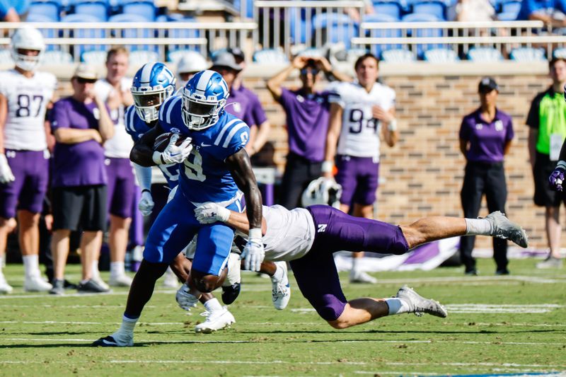 Sep 16, 2023; Durham, North Carolina, USA; Duke Blue Devils running back Jaquez Moore (9) runs with the football while Northwestern Wildcats attempts to tackle him during the first half  at Wallace Wade Stadium. Mandatory Credit: Jaylynn Nash-USA TODAY Sports