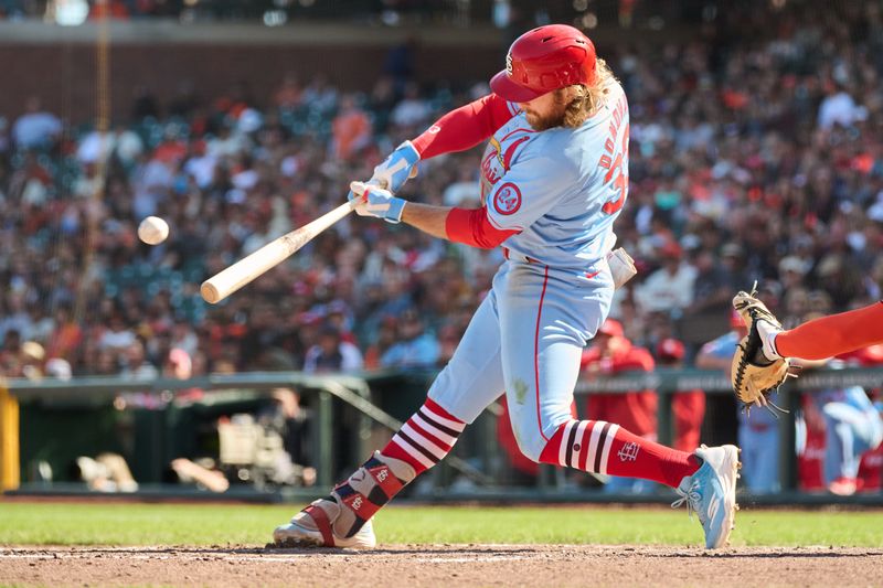 Sep 28, 2024; San Francisco, California, USA; St. Louis Cardinals outfielder Brendan Donovan (33) hits an RBI double against the San Francisco Giants during the seventh inning at Oracle Park. Mandatory Credit: Robert Edwards-Imagn Images