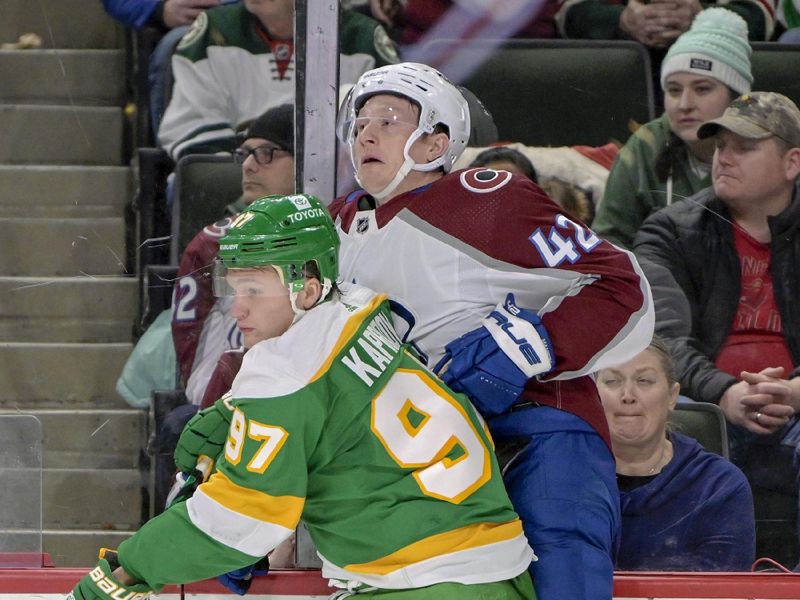 Nov 24, 2023; Saint Paul, Minnesota, USA; Minnesota Wild forward Kirill Kaprizov (97) finishes his check on Colorado Avalanche defenseman Josh Manson (42) during the second period at Xcel Energy Center. Mandatory Credit: Nick Wosika-USA TODAY Sports