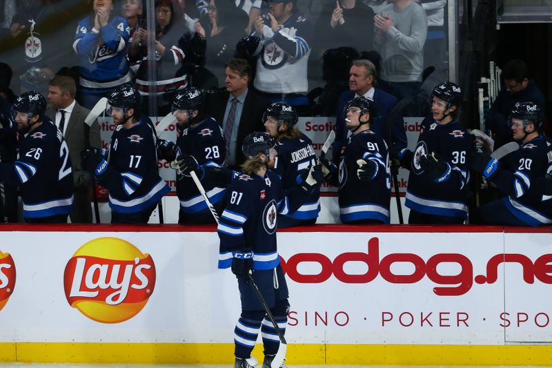 Jan 6, 2023; Winnipeg, Manitoba, CAN;  Winnipeg Jets forward Kyle Connor (81) is congratulated by his team mates on his goal against the Tampa Bay Lightning during the third period at Canada Life Centre. Mandatory Credit: Terrence Lee-USA TODAY Sports