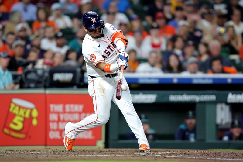 May 22, 2025; Houston, Texas, USA; Houston Astros third baseman Isaac Paredes (15) hits into a fielder's choice to score a run against the Seattle Mariners during the third inning at Daikin Park. Mandatory Credit: Erik Williams-Imagn Images
