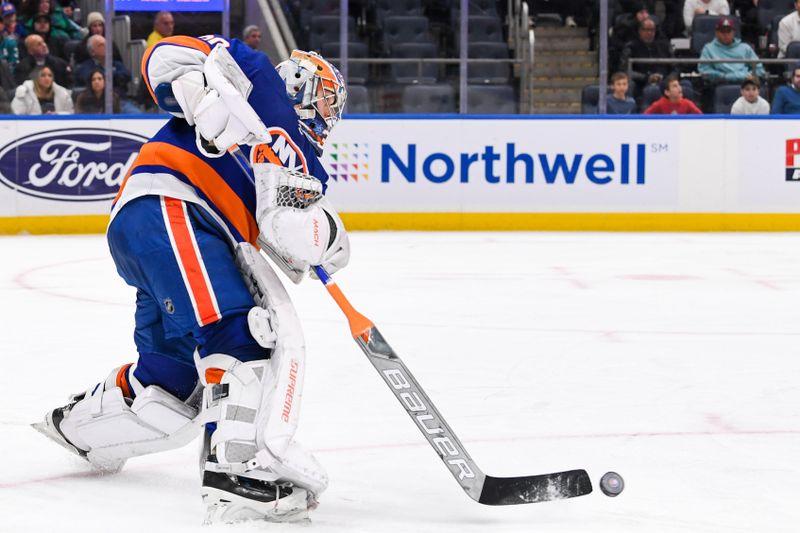 Dec 5, 2023; Elmont, New York, USA; New York Islanders goaltender Ilya Sorokin (30) passes the puck against the San Jose Sharks during the third period at UBS Arena. Mandatory Credit: Dennis Schneidler-USA TODAY Sports