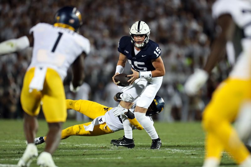 Sep 2, 2023; University Park, Pennsylvania, USA; Penn State Nittany Lions quarterback Drew Allar (15) tries to avoid a tackle during the second quarter against the West Virginia Mountaineers at Beaver Stadium. Penn State defeated West Virginia 38-15. Mandatory Credit: Matthew O'Haren-USA TODAY Sports