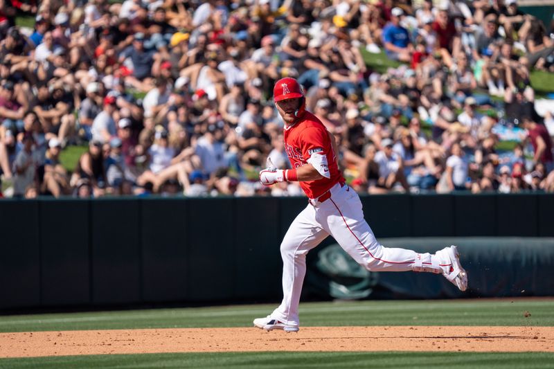 Mar 10, 2024; Tempe, Arizona, USA; Los Angeles Angels outfielder Mike Trout (27) looks back to check the play in the outfield enroute to a triple in the sixth during a spring training game against the San Diego Padres at Tempe Diablo Stadium. Mandatory Credit: Allan Henry-USA TODAY Sports