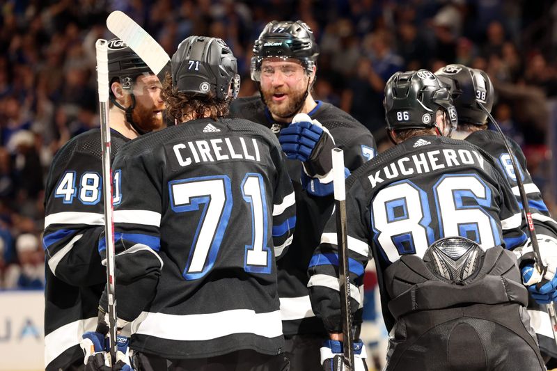 Feb 15, 2024; Tampa, Florida, USA; Tampa Bay Lightning right wing Nikita Kucherov (86) is Colorado Avalanche by Tampa Bay Lightning center Anthony Cirelli (71) and teammates after he scored a goal against the Colorado Avalanche during the first period at Amalie Arena. Mandatory Credit: Kim Klement Neitzel-USA TODAY Sports