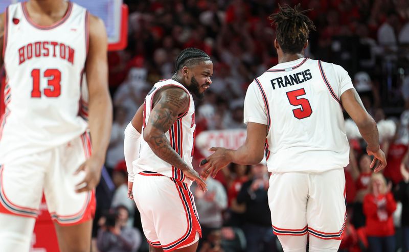 Feb 19, 2024; Houston, Texas, USA; Houston Cougars forward Ja'Vier Francis (5) celebrates with guard Jamal Shead (1) after scoring a basket during the second half against the Iowa State Cyclones at Fertitta Center. Mandatory Credit: Troy Taormina-USA TODAY Sports