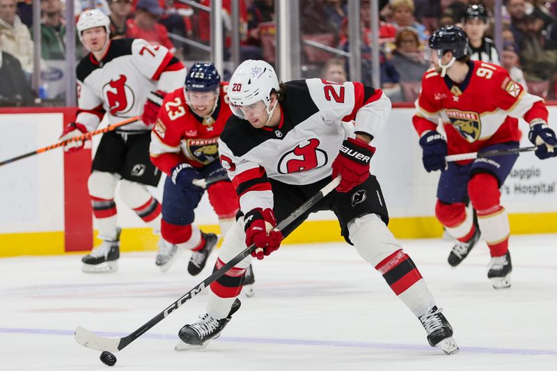 Jan 13, 2024; Sunrise, Florida, USA; New Jersey Devils center Michael McLeod (20) moves the puck against the Florida Panthers during the first period at Amerant Bank Arena. Mandatory Credit: Sam Navarro-USA TODAY Sports