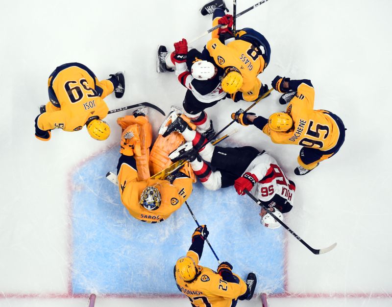 Jan 26, 2023; Nashville, Tennessee, USA; Nashville Predators goaltender Juuse Saros (74) makes a save in traffic on a shot by New Jersey Devils left wing Erik Haula (56) during the third period at Bridgestone Arena. Mandatory Credit: Christopher Hanewinckel-USA TODAY Sports