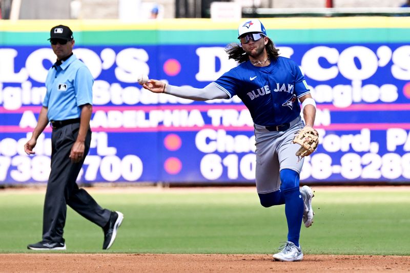 Mar 24, 2024; Clearwater, Florida, USA; Toronto Blue Jays shortstop Bo Bichette (11) throws to first base in the second  inning of the spring training game against the Philadelphia Phillies at BayCare Ballpark. Mandatory Credit: Jonathan Dyer-USA TODAY Sports