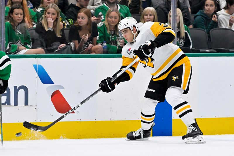 Mar 22, 2024; Dallas, Texas, USA; Pittsburgh Penguins defenseman Jack St. Ivany (3) dumps the puck into the Dallas Stars zone during the first period at the American Airlines Center. Mandatory Credit: Jerome Miron-USA TODAY Sports