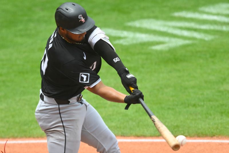 Jul 4, 2024; Cleveland, Ohio, USA; Chicago White Sox third baseman Lenyn Sosa (50) hits an RBI single in the second inning against the Cleveland Guardians at Progressive Field. Mandatory Credit: David Richard-USA TODAY Sports