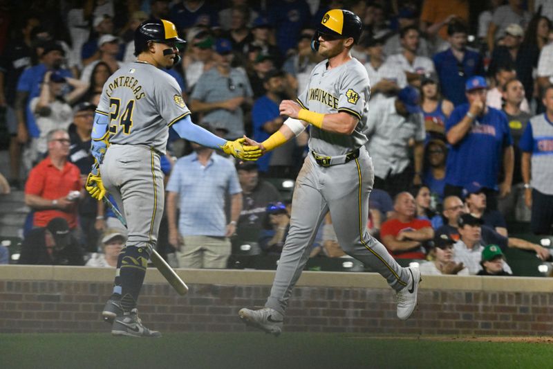 Jul 23, 2024; Chicago, Illinois, USA;  Milwaukee Brewers first base Jake Bauers (9) high fives Milwaukee Brewers catcher William Contreras (24) after scoring against the Chicago Cubs during the eighth inning at Wrigley Field. Mandatory Credit: Matt Marton-USA TODAY Sports