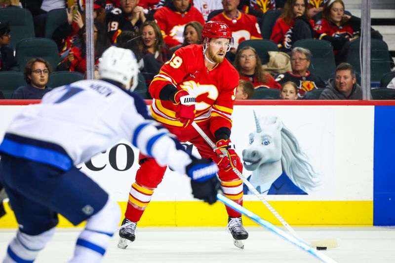 Oct 4, 2024; Calgary, Alberta, CAN; Calgary Flames right wing Anthony Mantha (39) controls the puck against the Winnipeg Jets during the second period at Scotiabank Saddledome. Mandatory Credit: Sergei Belski-Imagn Images