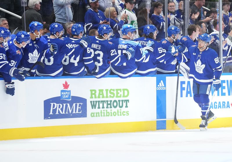 Oct 11, 2023; Toronto, Ontario, CAN; Toronto Maple Leafs right wing William Nylander (88) celebrates at the bench after scoring a goal  against the Montreal Canadiens during the second period at Scotiabank Arena. Mandatory Credit: Nick Turchiaro-USA TODAY Sports