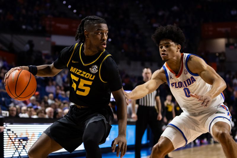 Feb 28, 2024; Gainesville, Florida, USA; Florida Gators guard Zyon Pullin (0) defends against Missouri Tigers guard Sean East II (55) during the first half at Exactech Arena at the Stephen C. O'Connell Center. Mandatory Credit: Matt Pendleton-USA TODAY Sports