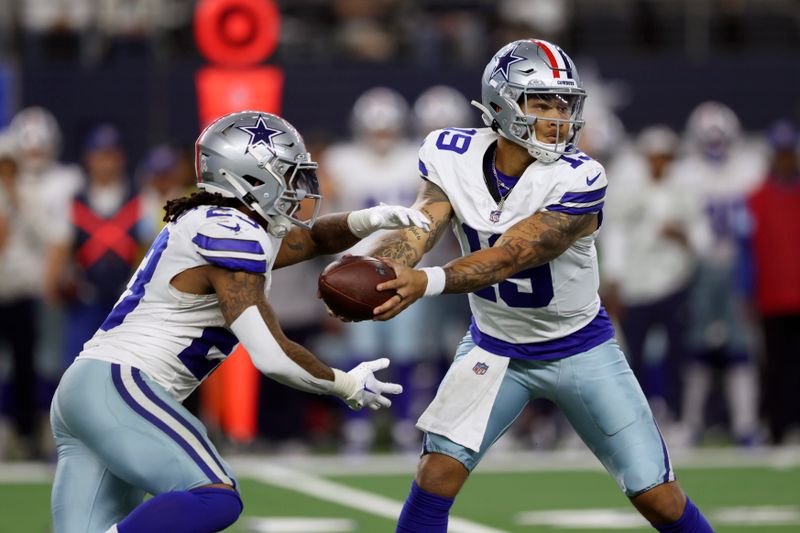 Dallas Cowboys quarterback Trey Lance (19) hands the ball off to running back Rico Dowdle in the second half of an NFL football game against the Philadelphia Eagles in Arlington, Texas, Sunday, Nov. 10, 2024. (AP Photo/Gareth Patterson)