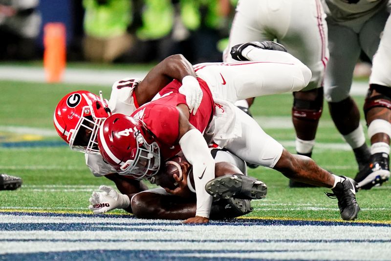 Dec 2, 2023; Atlanta, GA, USA;  Georgia Bulldogs linebacker Jalon Walker (11) sacks Alabama Crimson Tide quarterback Jalen Milroe (4) in the third quarter of the SEC Championship at Mercedes-Benz Stadium. Mandatory Credit: John David Mercer-USA TODAY Sports