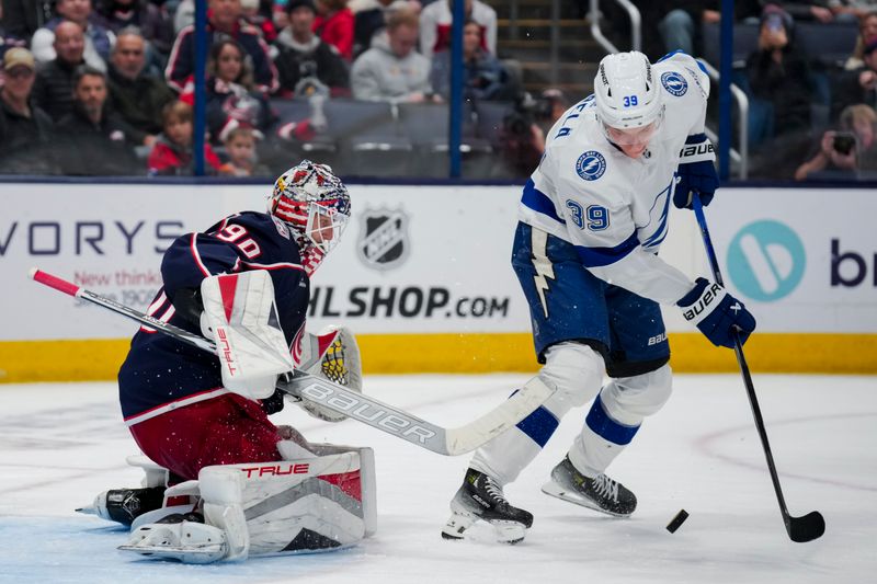 Nov 2, 2023; Columbus, Ohio, USA;  Columbus Blue Jackets goaltender Elvis Merzlikins (90) defends the net against Tampa Bay Lightning right wing Waltteri Merela (39) in the second period at Nationwide Arena. Mandatory Credit: Aaron Doster-USA TODAY Sports