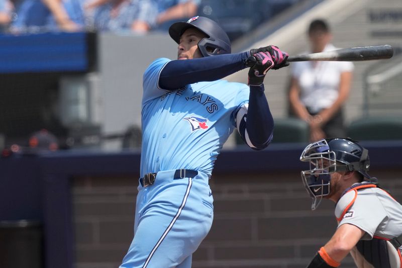 Jul 21, 2024; Toronto, Ontario, CAN; Toronto Blue Jays right fielder George Springer (4) hits his second solo home run of the game against the Detroit Tigers during the third inning at Rogers Centre. Mandatory Credit: John E. Sokolowski-USA TODAY Sports