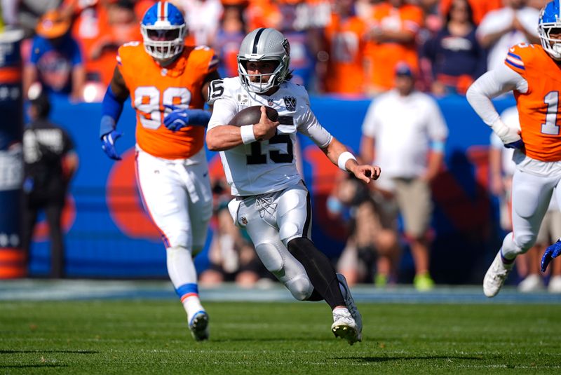 Las Vegas Raiders quarterback Gardner Minshew scrambles during the first half of an NFL football game against the Denver Broncos, Sunday, Oct. 6, 2024, in Denver. (AP Photo/David Zalubowski)