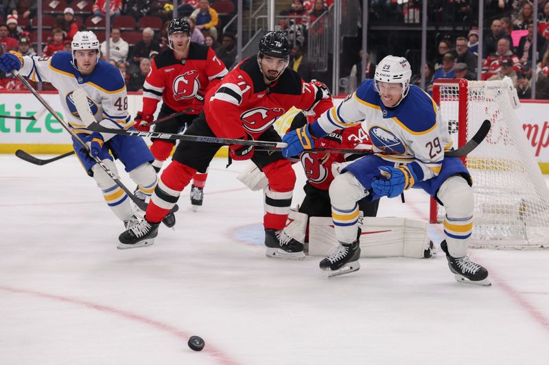 Feb 25, 2026; Newark, New Jersey, USA; New Jersey Devils defenseman Jonas Siegenthaler (71) and Buffalo Sabres left wing Beck Malenstyn (29) battle for the puck during the first period at Prudential Center. Mandatory Credit: Ed Mulholland-Imagn Images