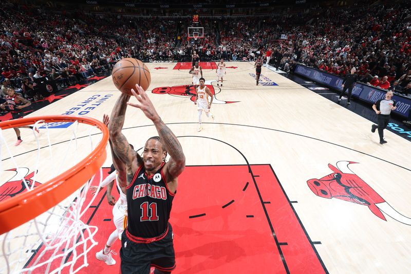 CHICAGO, IL - APRIL 17:  DeMar DeRozan #11 of the Chicago Bulls slam dunk the ball during the game  against the Atlanta Hawks during the 2024 Play-In Tournament  on April 17, 2024 at United Center in Chicago, Illinois. NOTE TO USER: User expressly acknowledges and agrees that, by downloading and or using this photograph, User is consenting to the terms and conditions of the Getty Images License Agreement. Mandatory Copyright Notice: Copyright 2024 NBAE (Photo by Jeff Haynes/NBAE via Getty Images)