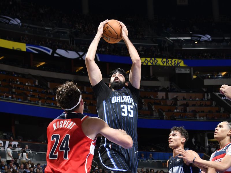 ORLANDO, FL - NOVMEBER 10: Goga Bitadze #35 of the Orlando Magic goes up for the rebound during the game against the Washington Wizards on November 10, 2024 at Kia Center in Orlando, Florida. NOTE TO USER: User expressly acknowledges and agrees that, by downloading and or using this photograph, User is consenting to the terms and conditions of the Getty Images License Agreement. Mandatory Copyright Notice: Copyright 2024 NBAE (Photo by Fernando Medina/NBAE via Getty Images)