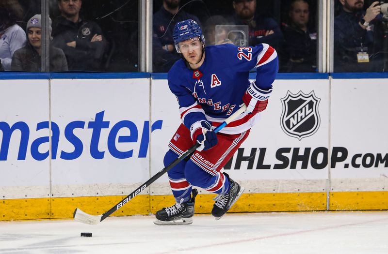 Jan 18, 2025; New York, New York, USA; New York Rangers defenseman Adam Fox (23) skates with the puck against the Columbus Blue Jackets during the second period at Madison Square Garden. Mandatory Credit: Danny Wild-Imagn Images