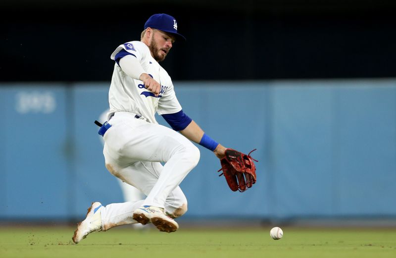 Jul 23, 2024; Los Angeles, California, USA; Los Angeles Dodgers second baseman Gavin Lux (9) chases a ground ball during the eighth inning against the San Francisco Giants at Dodger Stadium. Mandatory Credit: Jason Parkhurst-USA TODAY Sports