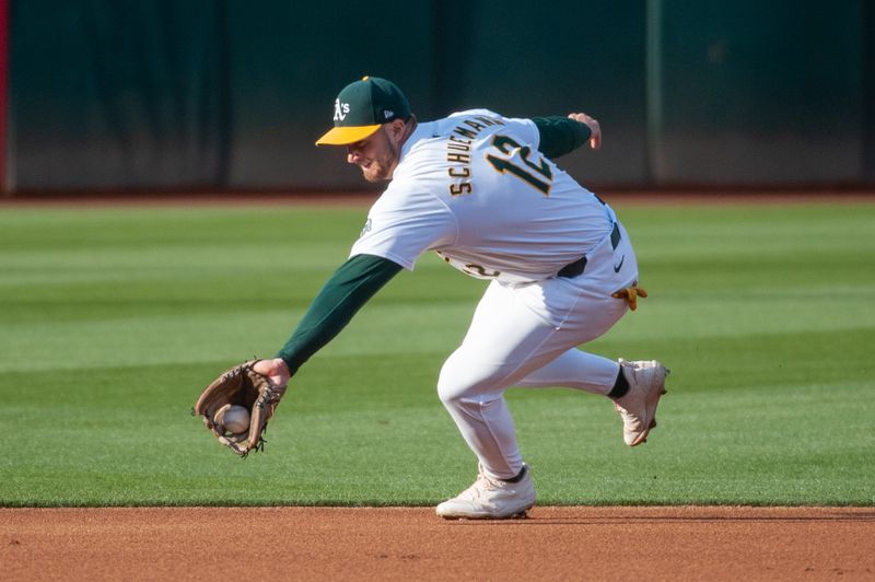 Jun 18, 2024; Oakland, California, USA; Oakland Athletics shortstop Max Schuemann (12) fields a ground ball during the first inning against the Kansas City Royals at Oakland-Alameda County Coliseum. Mandatory Credit: Ed Szczepanski-USA TODAY Sports