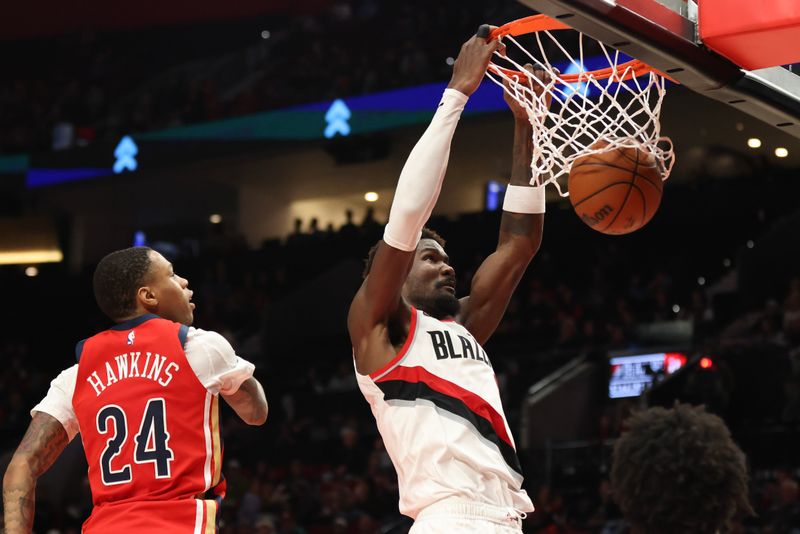 PORTLAND, OREGON - OCTOBER 27: Deandre Ayton #2 of the Portland Trail Blazers dunks beside Jordan Hawkins #24 of the New Orleans Pelicans during the fourth quarter at Moda Center on October 27, 2024 in Portland, Oregon. NOTE TO USER: User expressly acknowledges and agrees that, by downloading and or using this photograph, User is consenting to the terms and conditions of the Getty Images License Agreement.? (Photo by Amanda Loman/Getty Images)