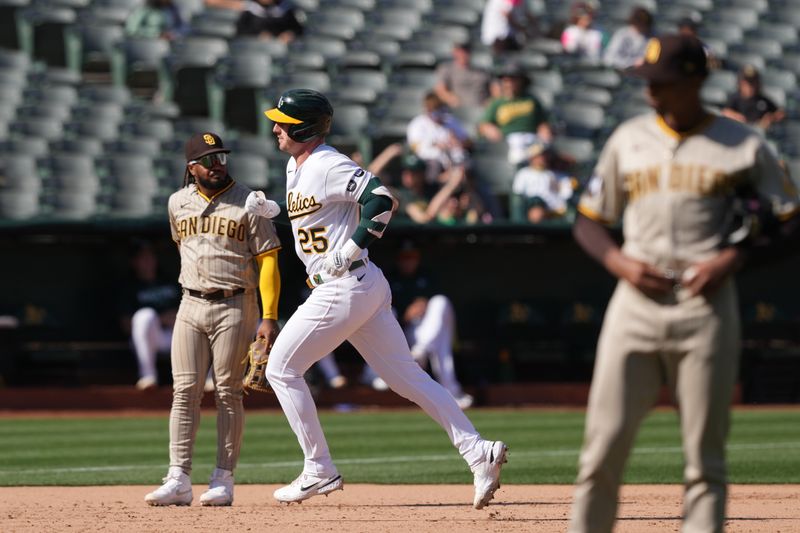 Sep 17, 2023; Oakland, California, USA; Oakland Athletics designated hitter Brent Rooker (25) rounds the bases after hitting a home run against San Diego Padres relief pitcher Ray Kerr (right) during the ninth inning at Oakland-Alameda County Coliseum. Mandatory Credit: Darren Yamashita-USA TODAY Sports